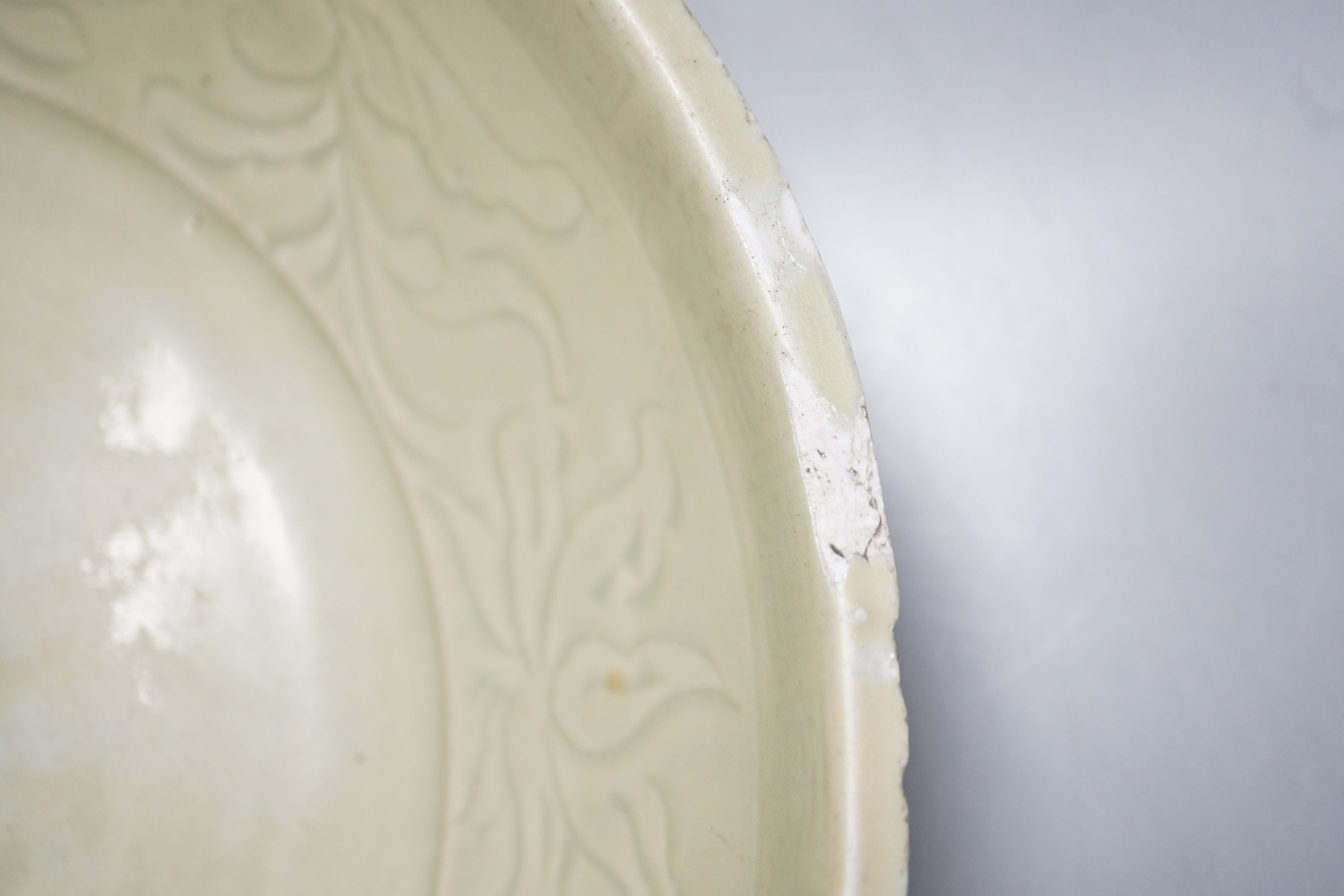 A Chinese Ming Longquan celadon dish, 15th/16th century, rim cut down, width 33cm